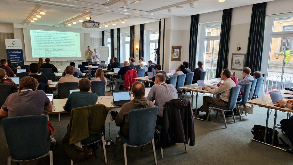 A session from the Ontologies4Chem workshop, with two speakers presenting and the attendees carefully listening