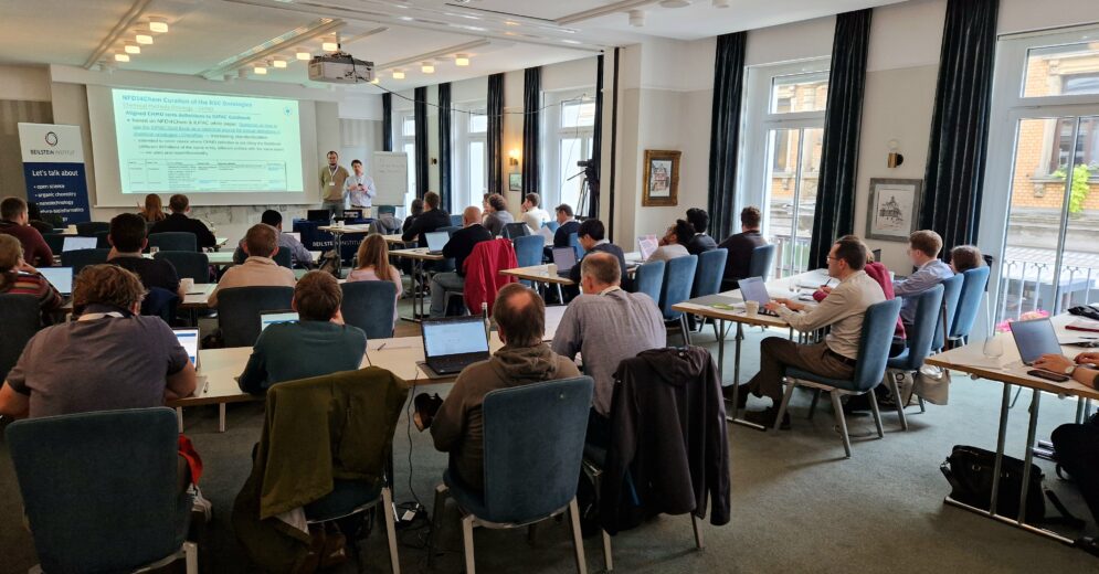 A session from the Ontologies4Chem workshop, with two speakers presenting and the attendees carefully listening